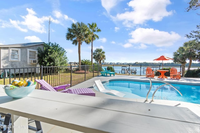 view of swimming pool with a water view and a patio area