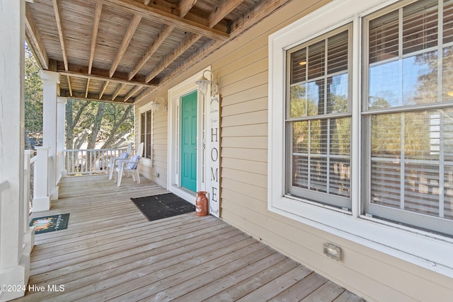 wooden terrace featuring covered porch