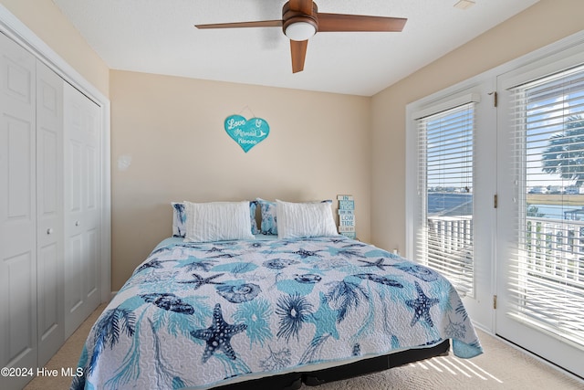 bedroom featuring carpet flooring, access to exterior, ceiling fan, and a closet