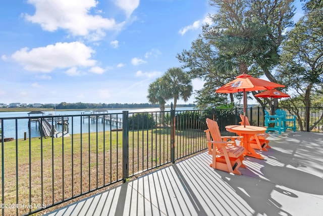 wooden terrace featuring a yard and a water view