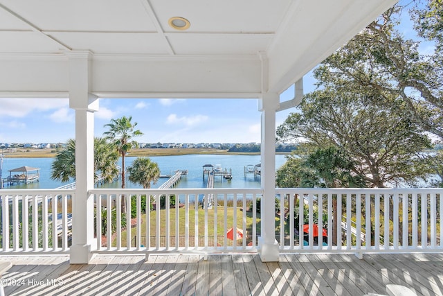 wooden terrace featuring a boat dock and a water view