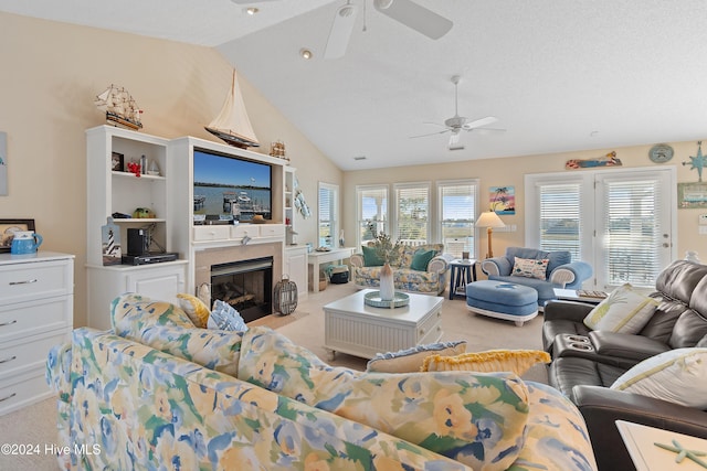 living room with a textured ceiling, ceiling fan, light carpet, and vaulted ceiling