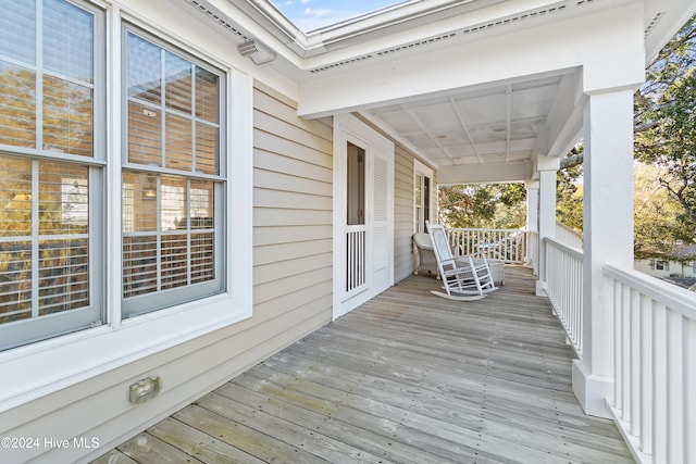 wooden terrace featuring covered porch