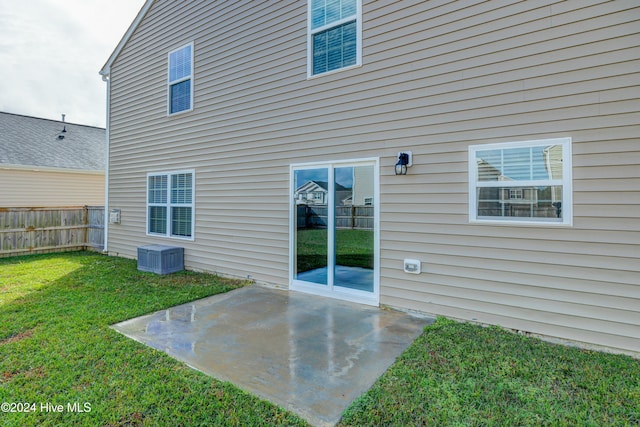 rear view of house featuring a yard and a patio