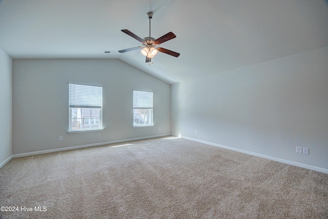 carpeted empty room with ceiling fan and vaulted ceiling