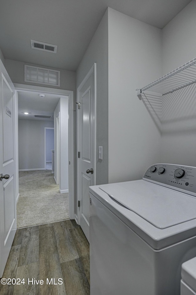 washroom with hardwood / wood-style floors and washer / dryer