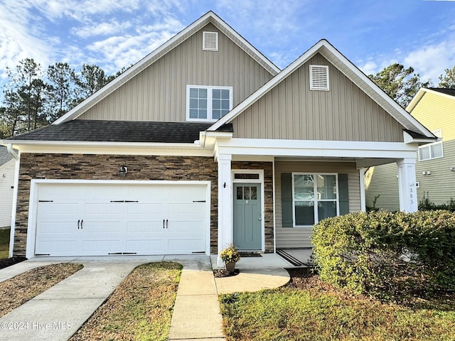 view of front of house with a porch and a garage