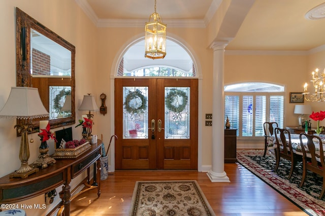 entryway featuring french doors, ornate columns, and hardwood / wood-style floors