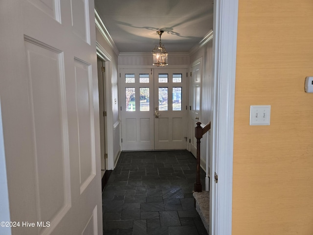 1112 Laurel Ln NW, Wilson, NC 27896 - doorway featuring stone tile floors, a chandelier, and crown molding