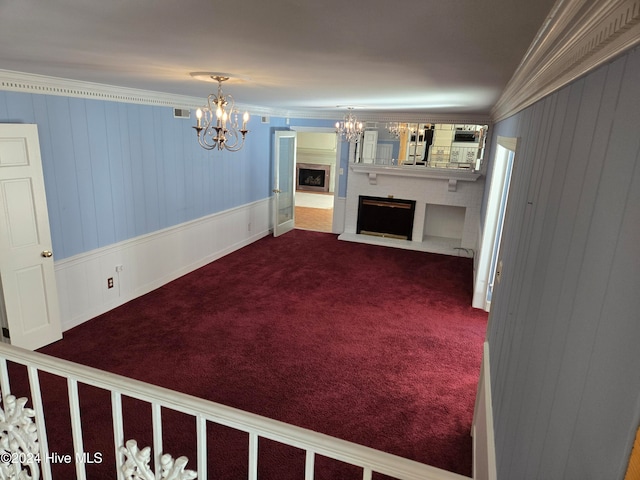 interior space featuring carpet, crown molding, and an inviting chandelier