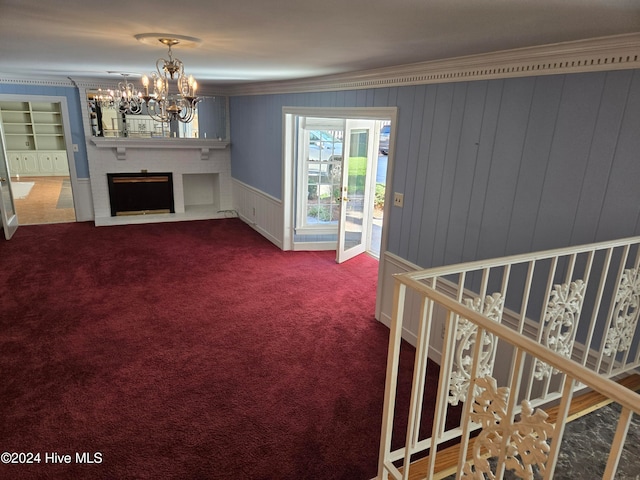 unfurnished living room with a fireplace, carpet floors, and ornamental molding