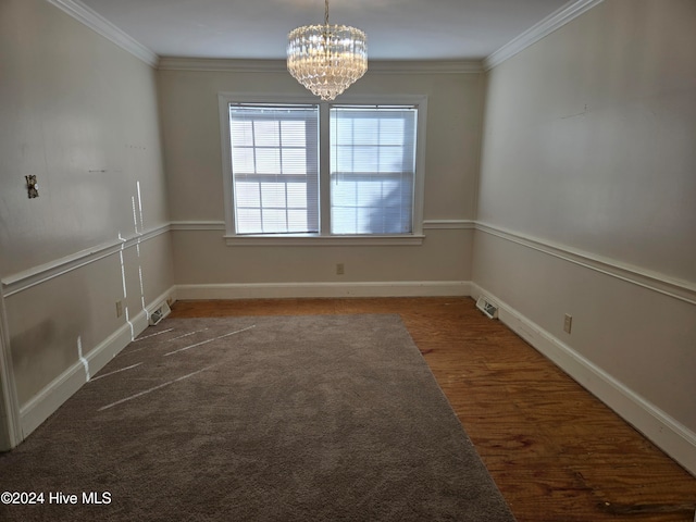 unfurnished dining area featuring crown molding, dark hardwood / wood-style floors, and a notable chandelier