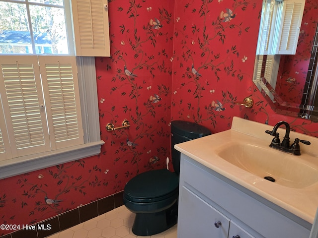 1112 Laurel Ln NW, Wilson, NC 27896 - half bathroom with vanity, tile patterned flooring, wallpapered walls, and toilet