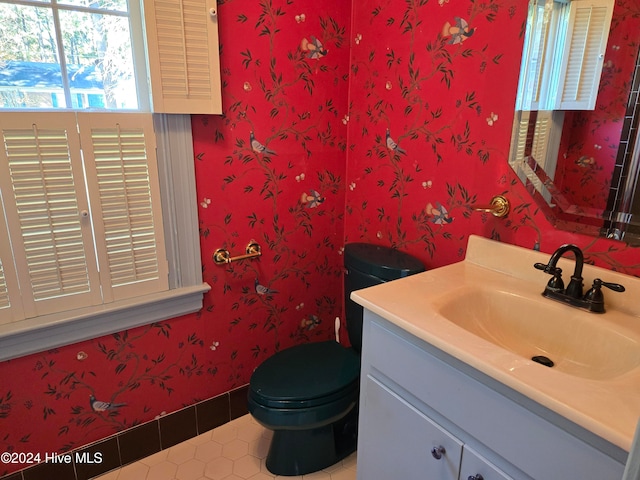 bathroom featuring tile patterned flooring, vanity, and toilet