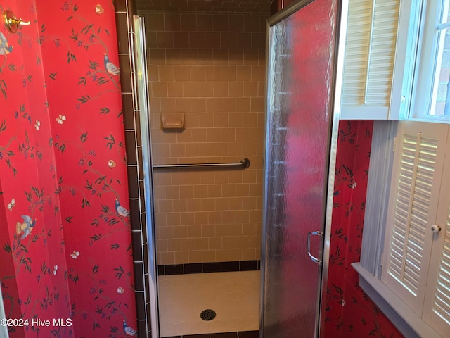 bathroom featuring a shower with door