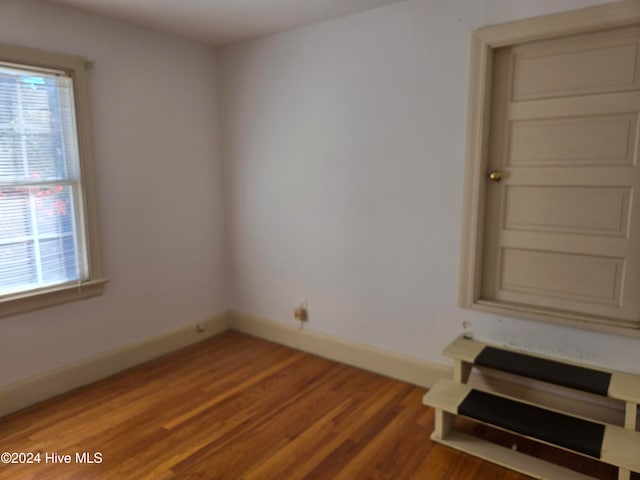 unfurnished room with hardwood / wood-style flooring