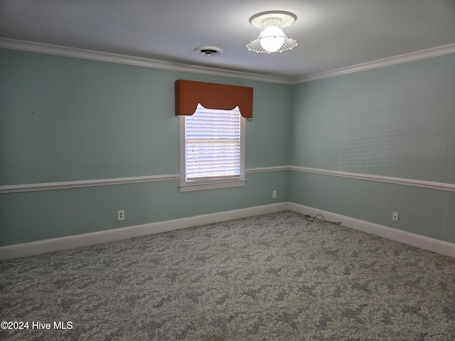 carpeted spare room featuring crown molding