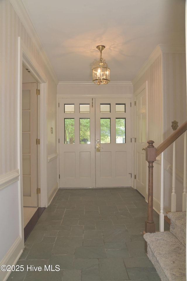 1112 Laurel Ln NW, Wilson, NC 27896 - entrance foyer featuring crown molding, a chandelier, stairway, and dark stone finish floors