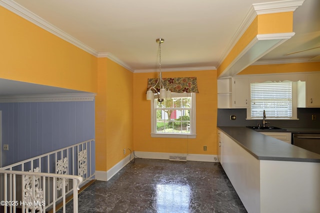 1112 Laurel Ln NW, Wilson, NC 27896 - unfurnished dining area with a sink, plenty of natural light, crown molding, and baseboards