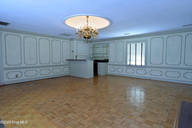1112 Laurel Ln NW, Wilson, NC 27896 - kitchen with a chandelier, a peninsula, hanging light fixtures, open floor plan, and dark countertops