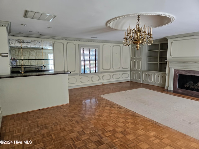 kitchen featuring a premium fireplace, dark parquet floors, pendant lighting, and an inviting chandelier