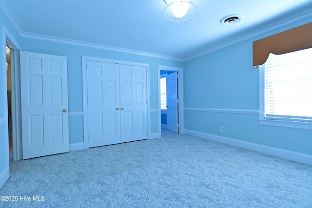 1112 Laurel Ln NW, Wilson, NC 27896 - unfurnished bedroom with carpet, crown molding, a closet, and baseboards