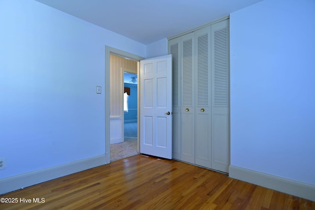 1112 Laurel Ln NW, Wilson, NC 27896 - unfurnished bedroom featuring wood finished floors, a closet, and baseboards