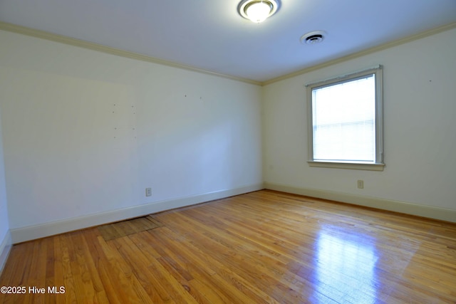 1112 Laurel Ln NW, Wilson, NC 27896 - spare room with ornamental molding, baseboards, and light wood-style flooring