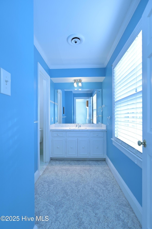 1112 Laurel Ln NW, Wilson, NC 27896 - bathroom featuring ornamental molding, vanity, toilet, baseboards, and carpet flooring