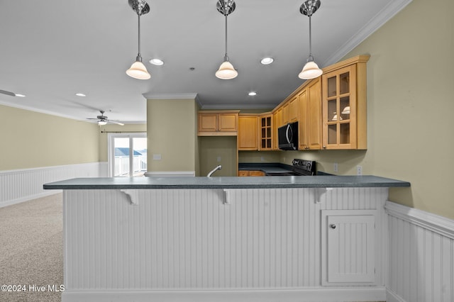 kitchen with a kitchen breakfast bar, kitchen peninsula, light carpet, black appliances, and ornamental molding