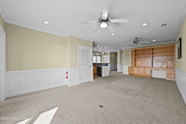 unfurnished living room with carpet floors, ceiling fan, and ornamental molding