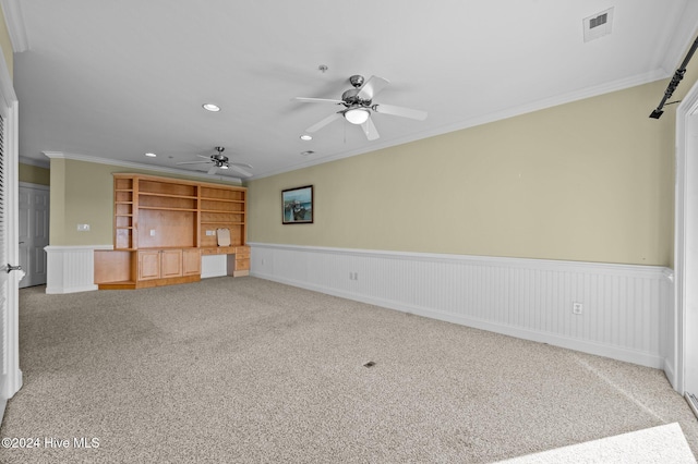 unfurnished living room with carpet flooring, ceiling fan, and ornamental molding