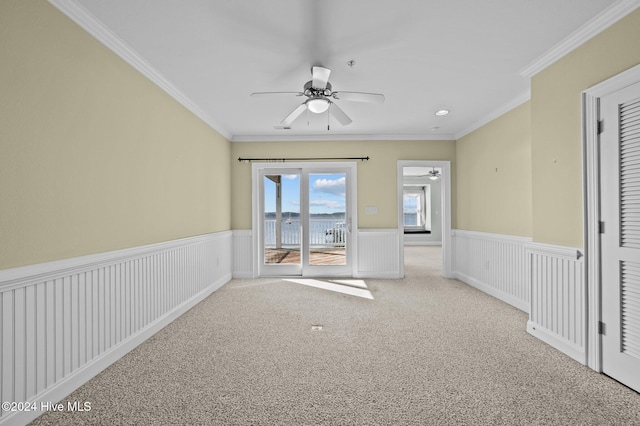 unfurnished room featuring light carpet, ceiling fan, and ornamental molding