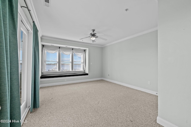 spare room with carpet flooring, ceiling fan, and crown molding