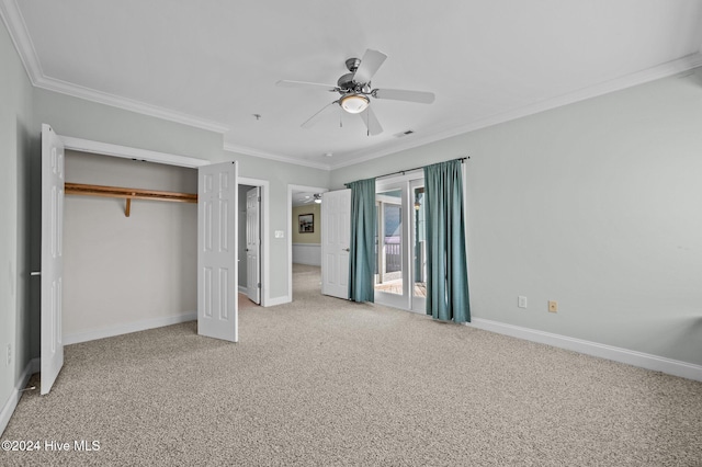 unfurnished bedroom with ceiling fan, a closet, carpet floors, and ornamental molding