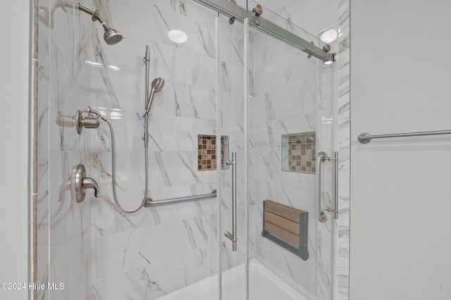 bathroom with a shower with shower door