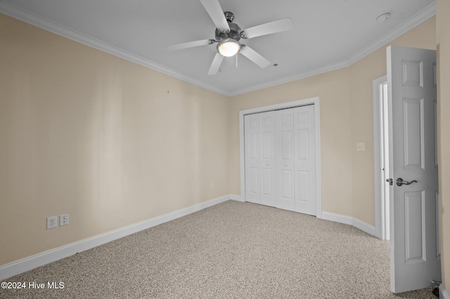 unfurnished bedroom featuring carpet, a closet, ceiling fan, and ornamental molding