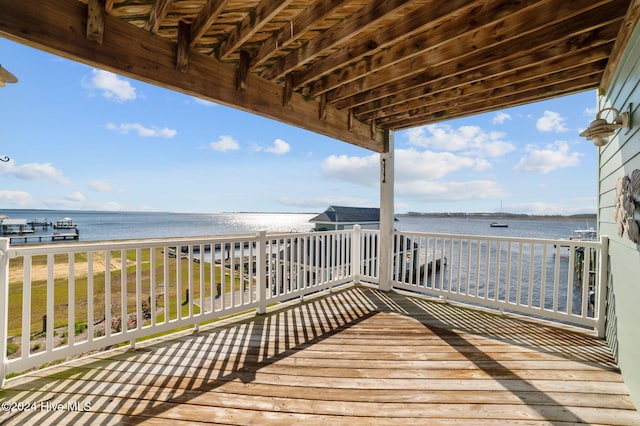 deck featuring a beach view and a water view