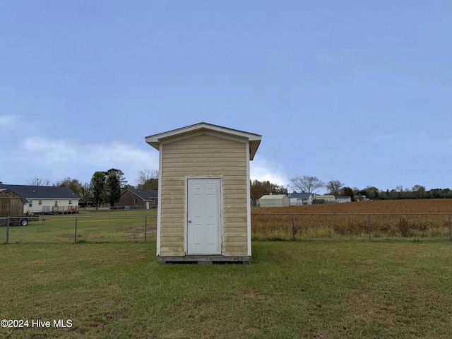 view of outdoor structure featuring a lawn