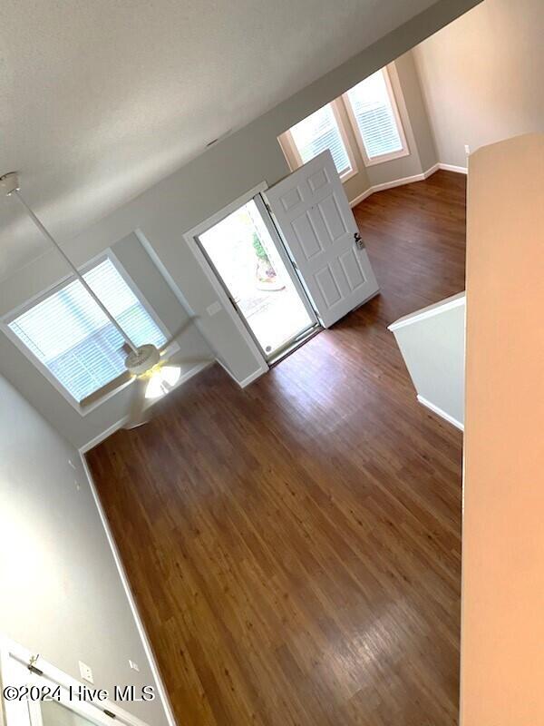 interior space featuring dark hardwood / wood-style flooring and lofted ceiling