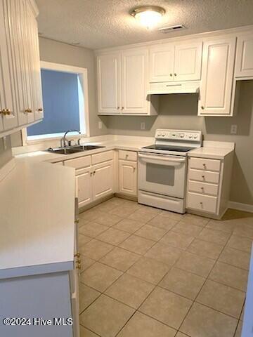 kitchen with white electric range oven, a textured ceiling, sink, light tile patterned floors, and white cabinetry