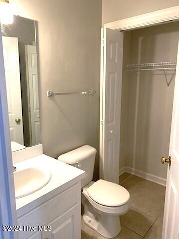 bathroom with tile patterned flooring, vanity, and toilet