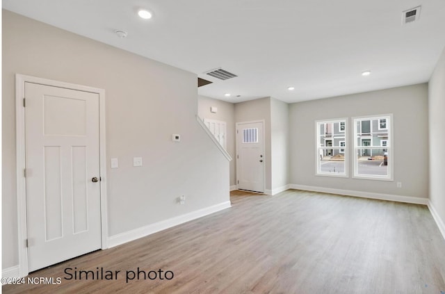 unfurnished room with light wood-type flooring