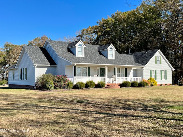 cape cod-style house featuring a front lawn and covered porch