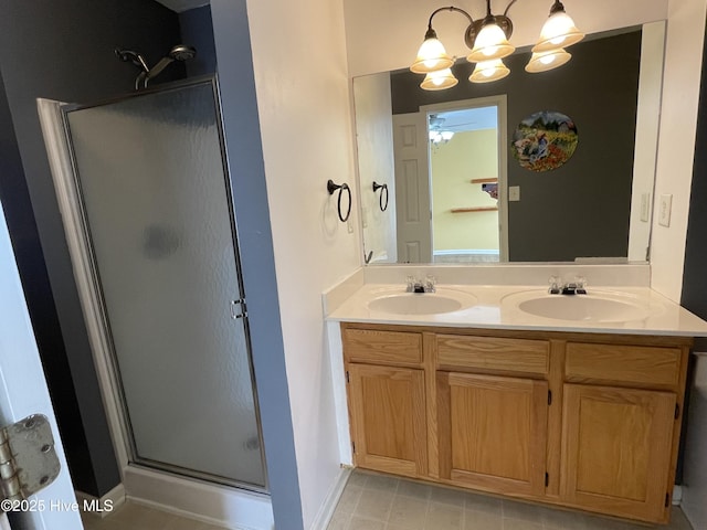 bathroom with vanity, an enclosed shower, and ceiling fan