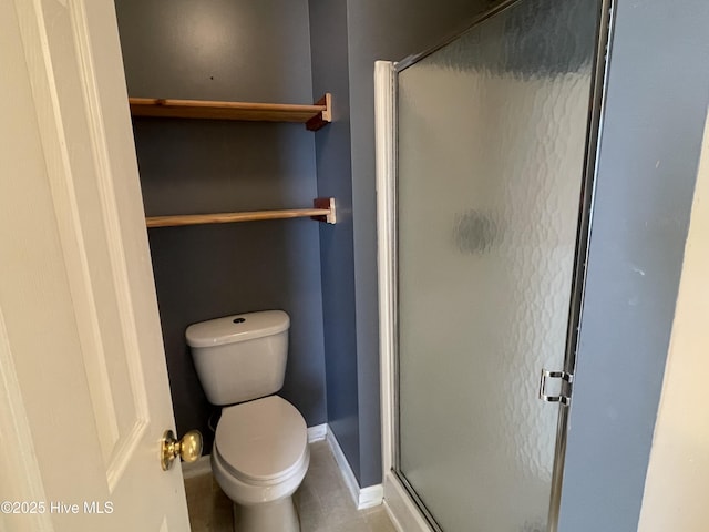 bathroom featuring tile patterned floors, toilet, and an enclosed shower