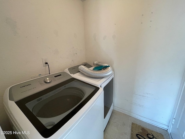 washroom featuring washer and clothes dryer