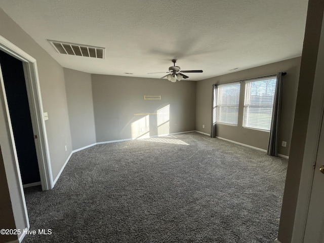 carpeted spare room with ceiling fan and a textured ceiling