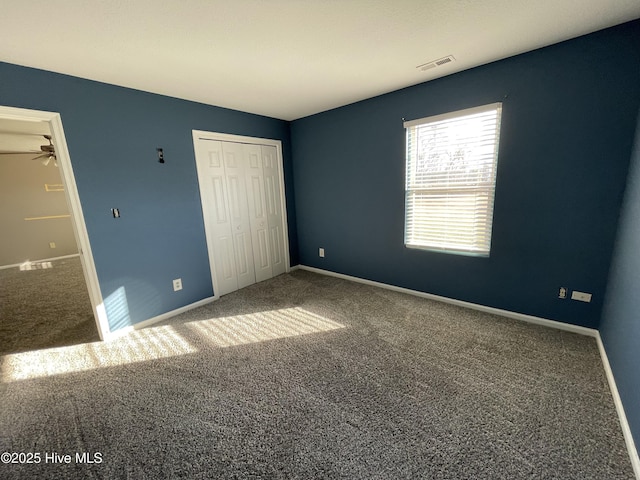 unfurnished bedroom with a closet and carpet floors