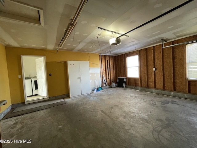 garage featuring washing machine and dryer and a garage door opener